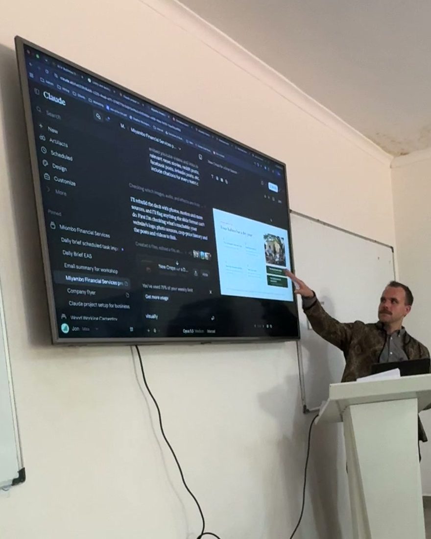 Jon Dallas pointing at a Claude Project on the big screen during the 21 October workshop